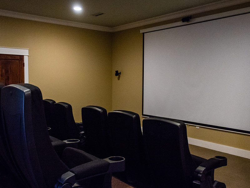Private movie theater with theater style seating that accommodates up to 14 people.